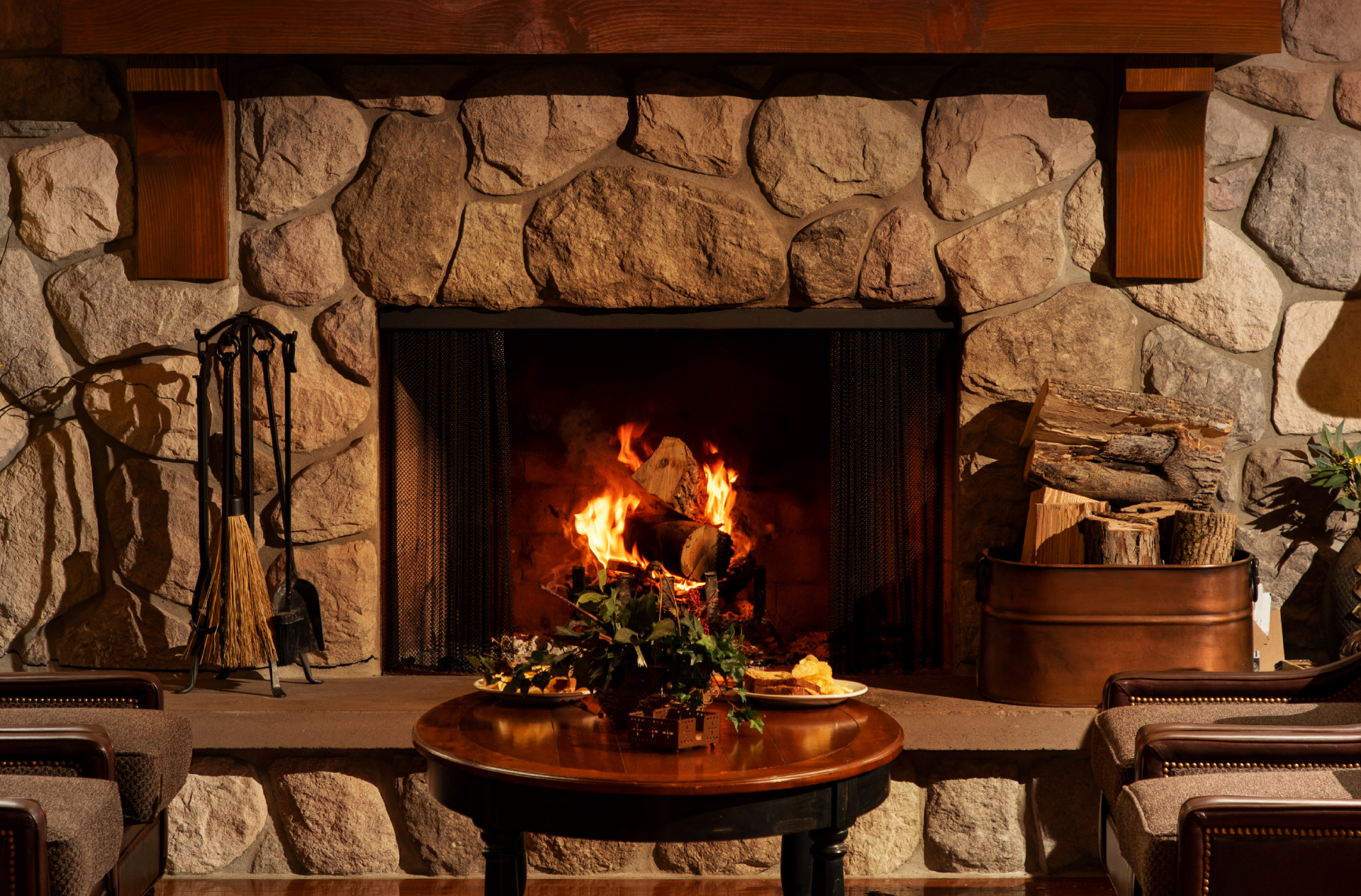 Image of chairs and table around fireplace